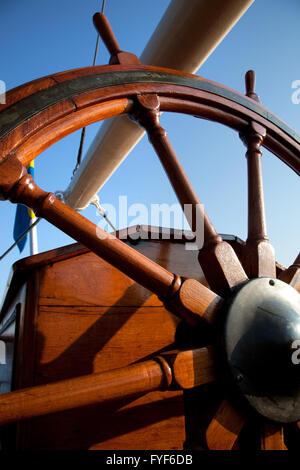 Helm, rudder of old wooden boat in dry dock, boat yard, covered with ...