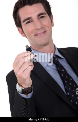 portrait of executive all smiles holding usb drive Stock Photo