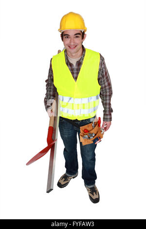 Man wearing reflective jacket and holding spade Stock Photo