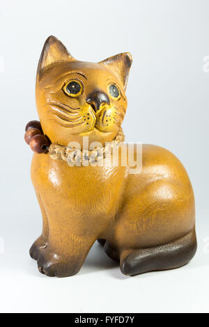 wooden statuette of a cat on a white background Stock Photo