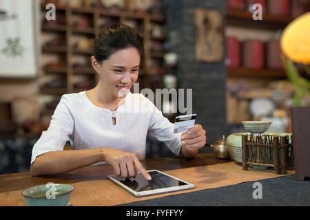 Tea house owner using digital tablet Stock Photo