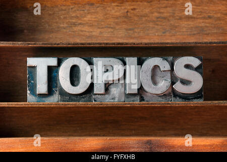 topics word made from metallic letterpress type on wooden tray Stock Photo