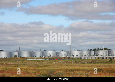 white tanks in tank farm with clouds in sky Stock Photo