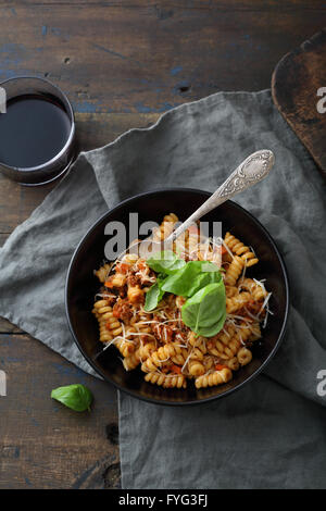 pasta with sauce in bowl on rustic table Stock Photo
