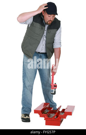 Handyman looking for a lost object in his toolbox Stock Photo