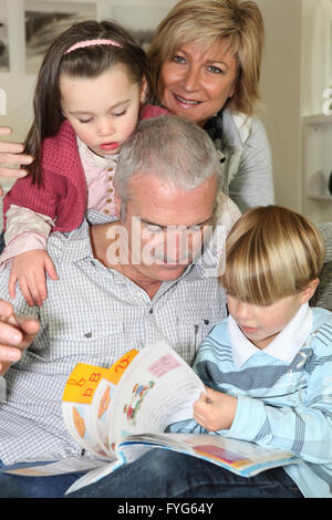 An elderly couple spending time with their grandchildren Stock Photo