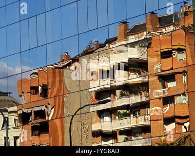 Reflection of apartment building in Barcelona in glass-fronted office building opposite Stock Photo