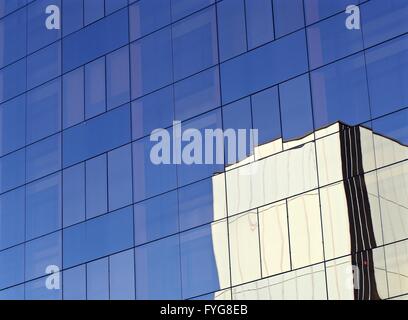 Reflections of white office building in glass-fronted building in Barcelona, Spain Stock Photo