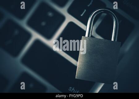 Encrypted Data Concept. Metal Padlock on the Computer Keyboard. Stock Photo