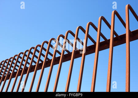 Metal fence with bent rods Stock Photo