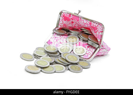isolated of wealth coins spilling from money bag Stock Photo