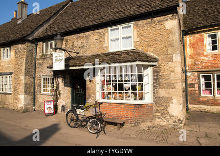 Old bicycle outside the village bakery shop, Lacock, Wiltshire, England, UK Stock Photo