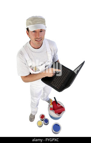 Decorator with pots of paint and an open laptop Stock Photo