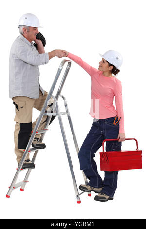 Experienced tradesman meeting his new apprentice for the first time Stock Photo