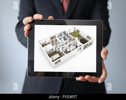 interior design concept: businessman with a tablet with interior design app on the screen Stock Photo