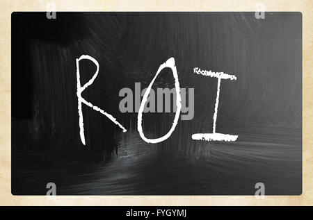 The word ROI handwritten with white chalk on a blackboard Stock Photo