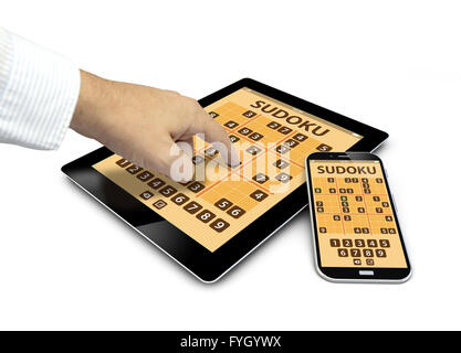 group of touchscreen devices with sudoku game and a hand touching the screen isolated on white background Stock Photo