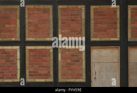 Half-timber texture with red and yellow bricks. Stock Photo