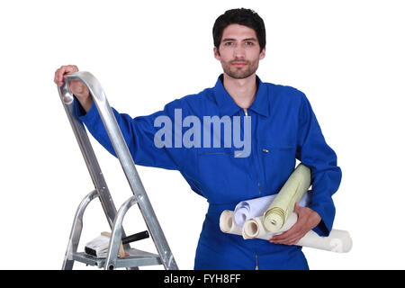 Decorator with step-ladder about to hang wallpaper Stock Photo