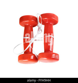 Two red dumbbell. Red dumbbells tied with satin ribbon. Isolated with clipping path on white background. Top view. Stock Photo