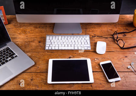 Desk, gadgets and office things. Flat lay. Wooden background. Stock Photo