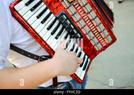 Man playing on a electronic accordion in natural light Stock Photo