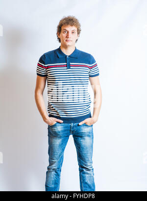 Young blonde adult caucasian man in casual clothes on a gray background. Not Isolated Stock Photo