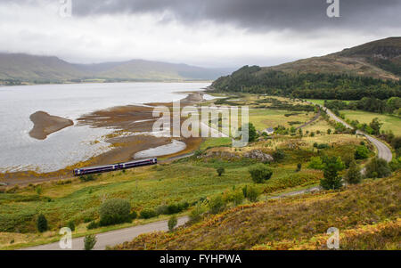 A Scotrail Class158 diesel multiple unit passenger train on the Kyle of Lochalsh railway line at Attadale, beside Loch Carron. Stock Photo