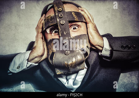 pulling, dangerous business man with iron mask and expressions Stock Photo