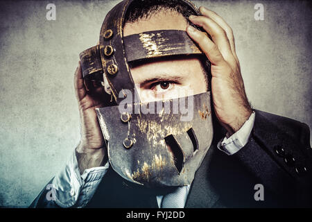 frustrated, dangerous business man with iron mask and expressions Stock Photo