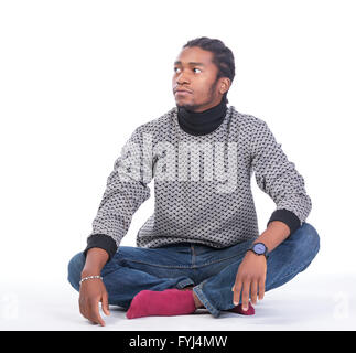 Young African-American male sitting on the ground Stock Photo