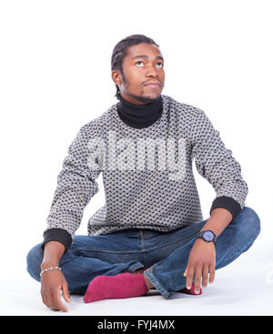 Young African-American male sitting on the ground Stock Photo
