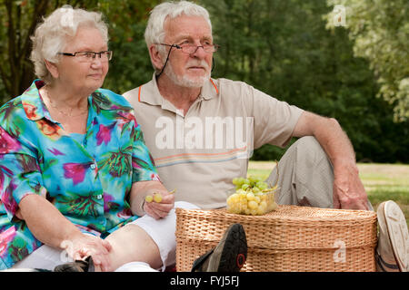 Senior couple sitting in the park Stock Photo