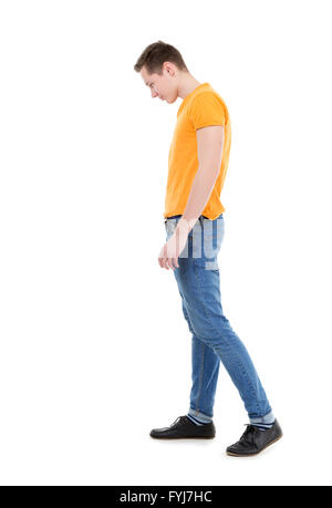 Young man wearing a yellow T-shirt and slim jeans Stock Photo