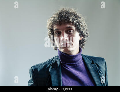 Detailed portrait of a young caucasian guy with curly hair Stock Photo