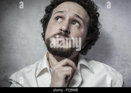 Male decisionmaking, man in white shirt with funny expressions Stock Photo