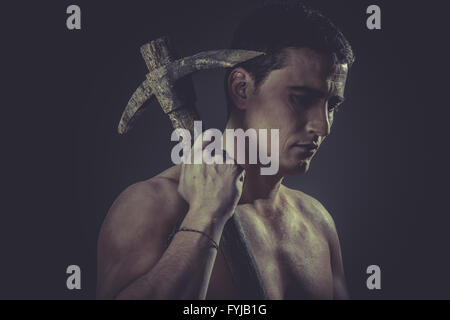 Tool, Construction worker portrait holding a peak. Stock Photo