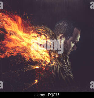 fallen angel, jacket man with golden feathers on the wings and fire Stock Photo