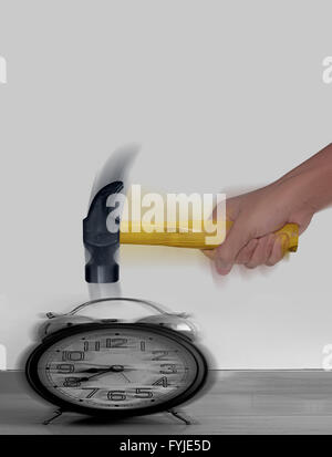 Hammer hitting Alarm Clock with motion blur Stock Photo