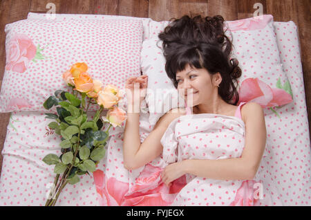 Young beautiful girl woke up on his birthday Stock Photo