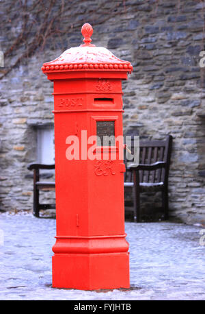 Old English style red mailbox in a snow covered square in New Zealand. Stock Photo