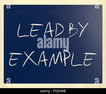 Lead by example handwritten with white chalk on a blackboard Stock Photo