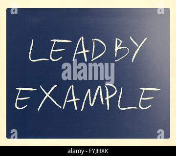 Lead by example handwritten with white chalk on a blackboard Stock Photo