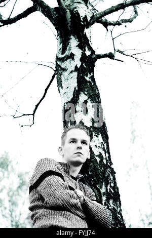 Boy and the dead tree Stock Photo