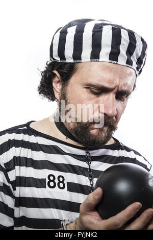 Punishment, one caucasian man prisoner criminal with chain ball and handcuffs in studio isolated on white background Stock Photo