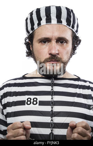 Trapped, one caucasian man prisoner criminal with chain ball and handcuffs in studio isolated on white background Stock Photo