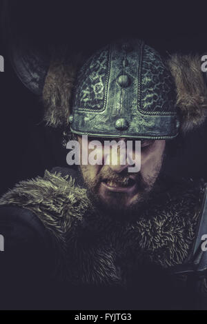 Furious, Costume, Viking warrior with a huge sword and helmet with horns Stock Photo