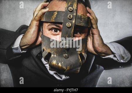 manager, dangerous business man with iron mask and expressions Stock Photo