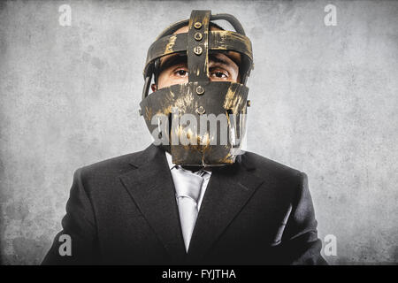 office, dangerous business man with iron mask and expressions Stock Photo