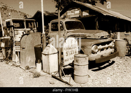 Early 1950's Ford F100 pickup truck leading the line at the gas pumps at an old South West USA mining town's general store. Stock Photo